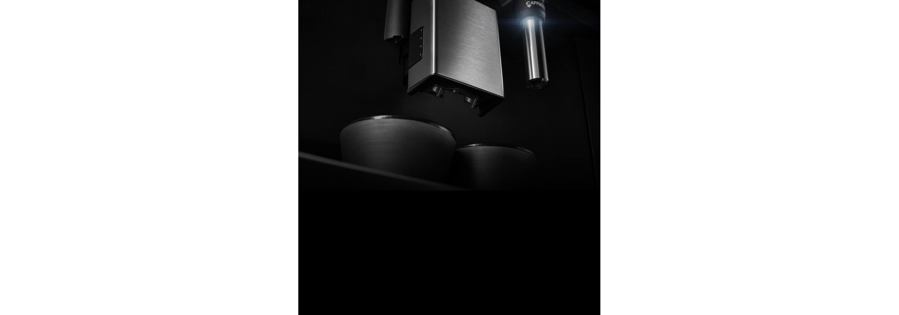 A close up of the coffee maker's dual dispensing spouts.