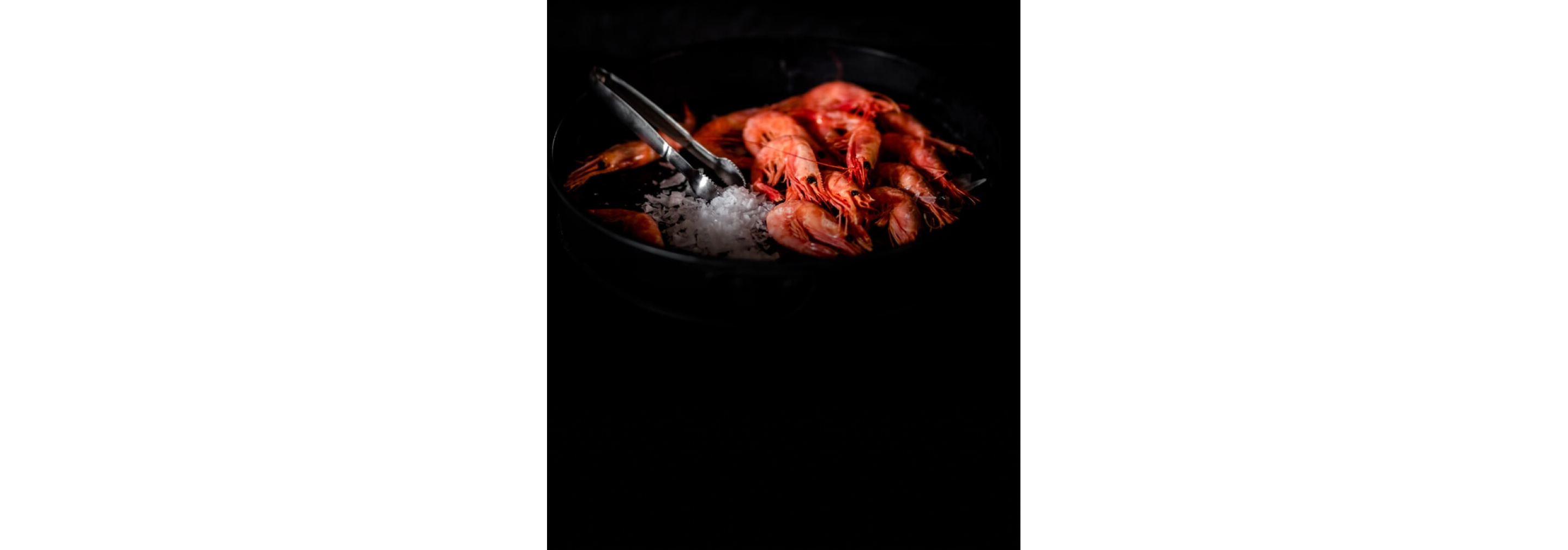 Colorful steamed shrimp in an ice bath. 