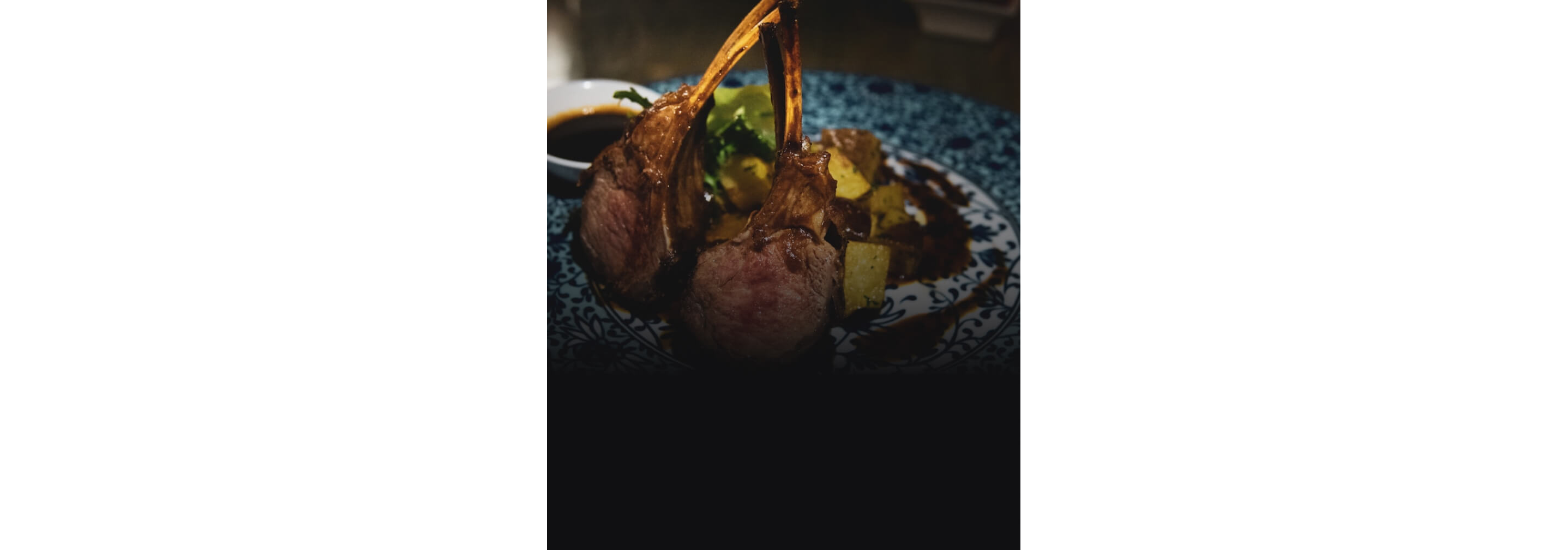 Lamb chops arranged on a blue plate.